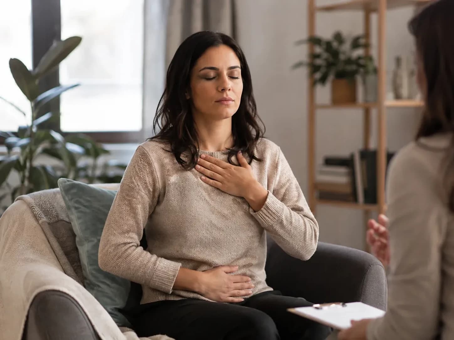 Therapist guiding a client through a breathing exercise