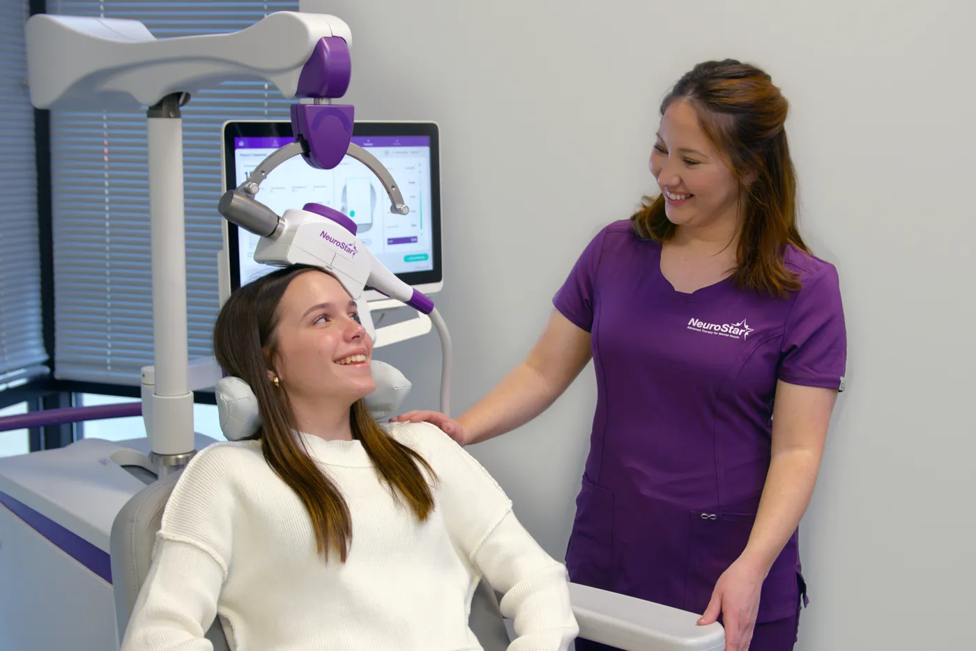 A person receiving NeuroStar TMS therapy in a treatment chair